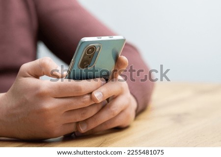 Man hands holding smartphone. Man using smartphone and pointing on the screen with one finger