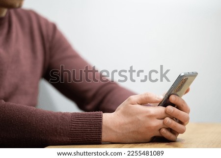 Man hands holding smartphone. Man using smartphone and pointing on the screen with one finger