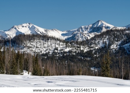 Snow Capped High Mountain Peaks are Backdrops to Wolf Creek Ski Area, Colorado. The San Juan Mountains receive generous amounts of snow, that provides great Winter recreation.  Royalty-Free Stock Photo #2255481715
