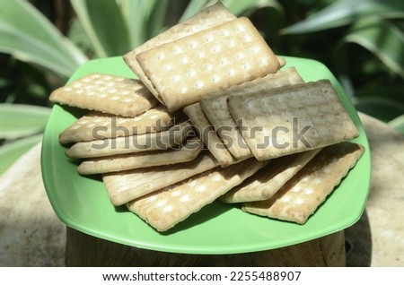 some pastries sprinkled with sugar placed on a wooden plate, Yogyakarta, Indonesia. shooting is done from a higher angle than the object or high angle