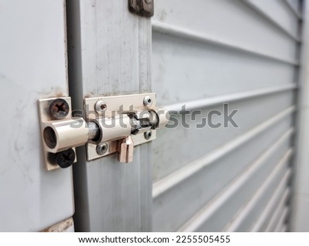 Latch made of iron material to lock the iron bathroom door.