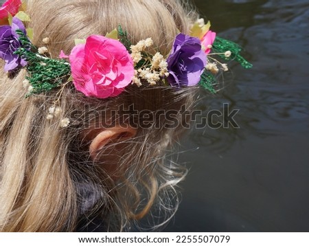 Blond Girl with Flower Crown Looking Into Water in Xochimilco Mexico