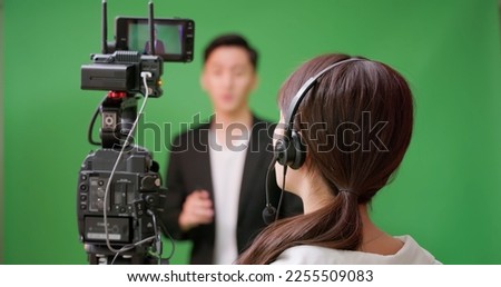 Female Asian Videographer satisfied with result of video shooting