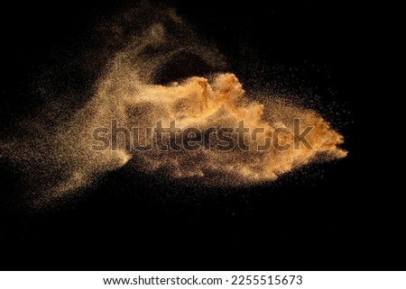Dry river sand explosion. Brown colored sand splash against  black background. Royalty-Free Stock Photo #2255515673