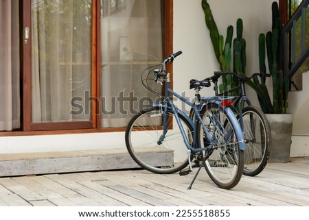 Classic bike in front of house in natural sunlight.
