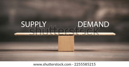 Supply and Demand word on wooden balance scales. Business concept Royalty-Free Stock Photo #2255585215
