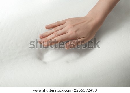 Woman with memory foam pillow on white background, closeup Royalty-Free Stock Photo #2255592493