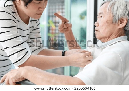 Angry asian senior grandmother scolding woman,Aggressive old elderly people shouting pointing finger at frightened female caregiver,dissatisfaction irritated,violence aggression,mental health concept Royalty-Free Stock Photo #2255594105