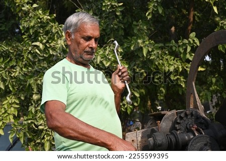 Portrait of an Indian senior man doing his work