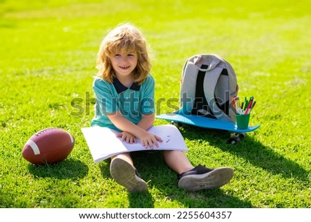 Little painter draw pictures outdoor. Child drawing picture with crayon in summer park outdoor. Happy little kid boy holding a brush to paint with toys for playing outdoor.