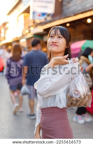 Picture of a woman walking shopping at Chiang Khan Walking Street Market. Chiang Khan District, Loei Province, Thailand