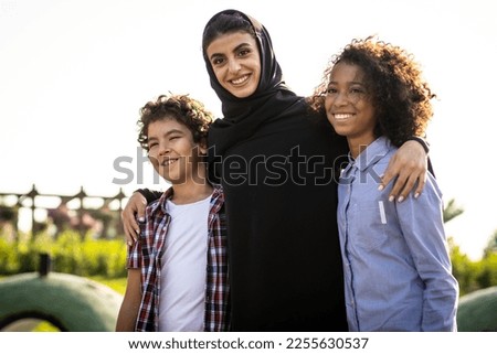 Cinematic image of a family playing at the playground in Dubai Royalty-Free Stock Photo #2255630537