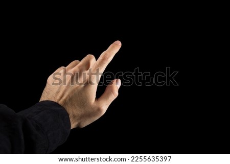 Man's hand pointing index finger on a black background. The river makes a choice