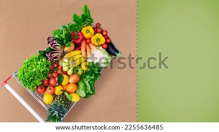 Supermarket shopping cart full of fresh vegetables and fruits, copy space Royalty-Free Stock Photo #2255636485