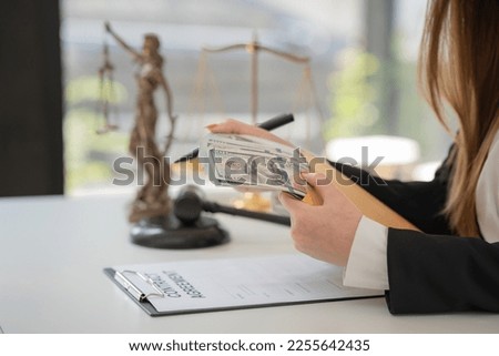 Selective focus, a woman offering a batch of hundred dollar bills. Hands close up. Venality, bribe, corruption concept.  Royalty-Free Stock Photo #2255642435