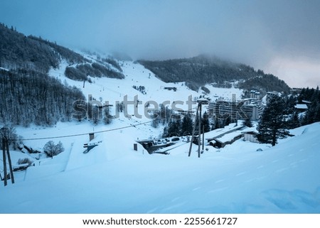 Ski resort in Gourette on a frosty winter day with cable cars and lifts taking skiers to the top of the mountain in the Pyrénées-Atlantiques, France