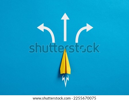 Business decision making and the way to success. Choosing a strategic path to move forward. Alternative options and business solutions. Paper plane with arrows pointing different directions. Royalty-Free Stock Photo #2255670075