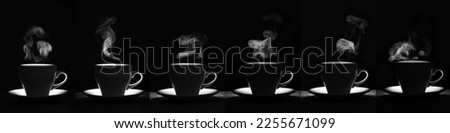 A set of white mugs with a warm drink and a curly fantasy steam rising up on a black background, creative, layout, silhouette. A steaming coffee cup and saucer. Morning coffee. Royalty-Free Stock Photo #2255671099