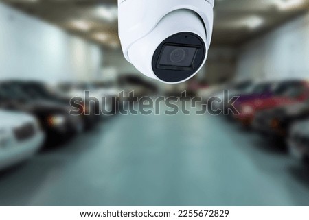 CCTV security camera on blur car parking. Copy space