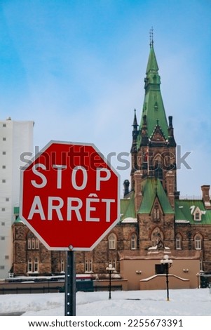 Arret stop sign over Canadian Parliament building in Ottava, Canada at winter