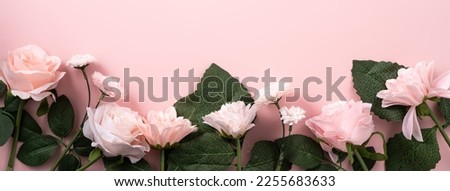 Valentine's Day and Mother's Day design concept background with pink rose, carnation flower and wrapped gift box on pink table background.