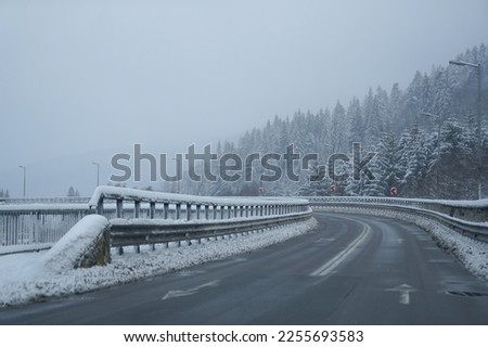 road. bridge over a valley in winter. the snow. low road traffic due to weather phenomena. Royalty-Free Stock Photo #2255693583