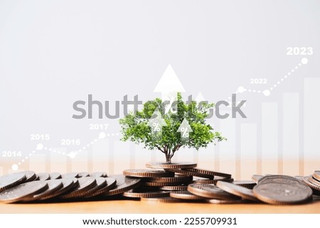 Tree growing on coins stacking with up arrow and increasing graph for money saving and deposit growth from investment profit , Financial banking concept.