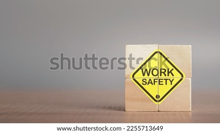 Work safety concept. Work Safety text yellow in wooden cube and copy spec. Safety first sign on virtual screen. Hazards, protections, regulations and insurance, Zero accidents, Protection dangerous. Royalty-Free Stock Photo #2255713649