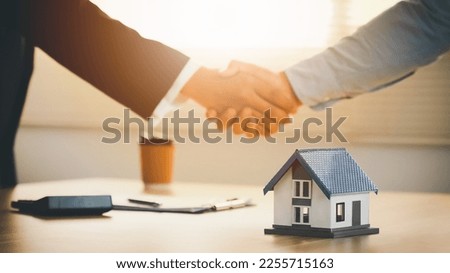 Real estate agents and customers congratulate after signing a contract to buy a house with land and insurance, concept, real estate, broker or home insurance, etc.
