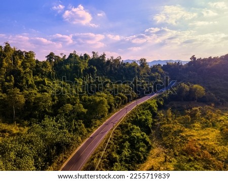 Mountain road. road with a tunnel of trees on mountain.long road in countryside of Thailand.winding road .