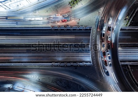 Expressway top view, Road traffic an important infrastructure, Drone aerial view fly in circle, traffic transportation, Public transport or commuter city life concept of economic and energ, transport. Royalty-Free Stock Photo #2255724449