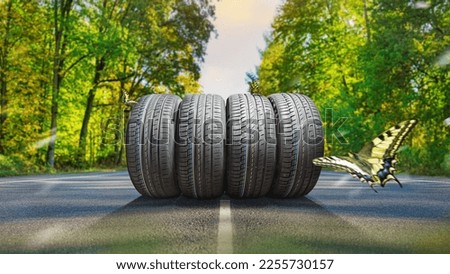 summer tires on the asphalt road in the sun - time for summer tires Royalty-Free Stock Photo #2255730157