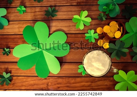 view from above. copy space beer on wooden table, green clover and gold coins. st. patrician's day.