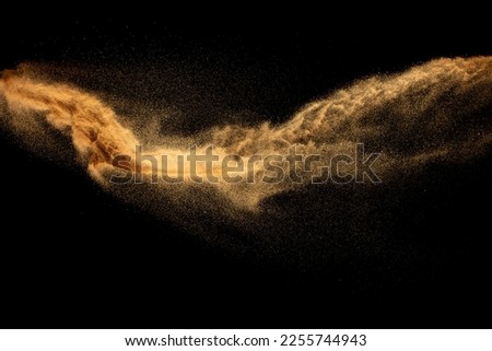 Dry river sand explosion.Brown color sand splash against black background. Royalty-Free Stock Photo #2255744943