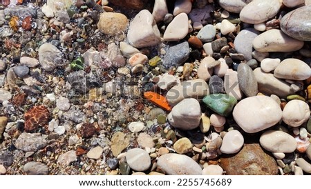 photo of the sea coast with pebbles