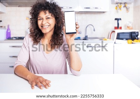Happy black woman showing smartphone display with white empty copy text copy space