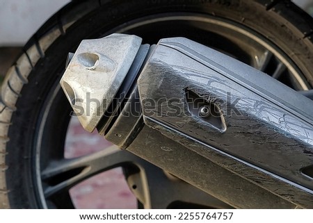 Close-up of a dirty motorcycle muffler side view                   