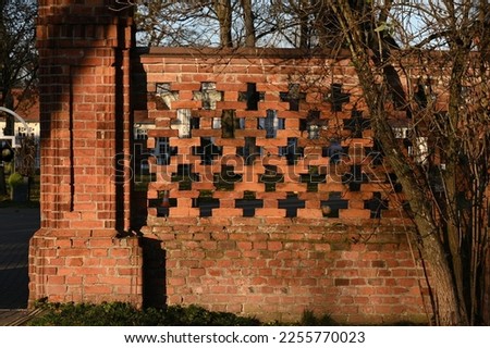 historic high fence of red brick masonry