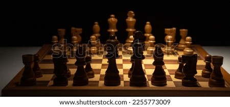 chess game chess figures on an old wooden table, black background  copy space, the hand of a businessman moving chess figure, strategy ideas concept,   Board King, Queen, rook, knight