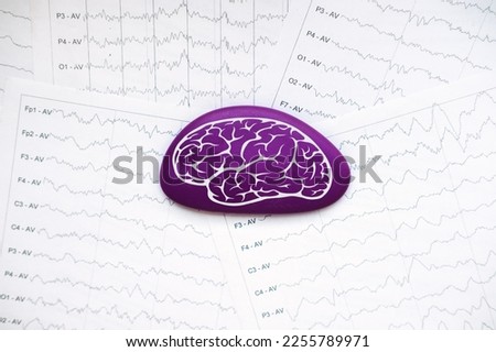 International Epilepsy Day, Epilepsy awareness. Purple brain drawing on brain wave on electroencephalogram EEG for epilepsy Royalty-Free Stock Photo #2255789971