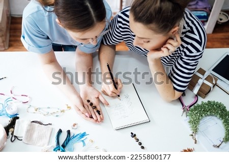 Money making crafts do at home, how to make money crafting. Small local business. Two Female jewelry artists making jewelry. Two business owner women designing jewelry in workshop, studio Royalty-Free Stock Photo #2255800177