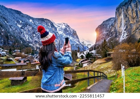 Tourist visiting village of Lauterbrunnen in the Bernese Oberland, Switzerland. Royalty-Free Stock Photo #2255811457