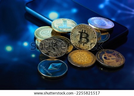 Several golden cryptocurrencies highlighting the Bitcoin coin with graphics in blue color Royalty-Free Stock Photo #2255821517