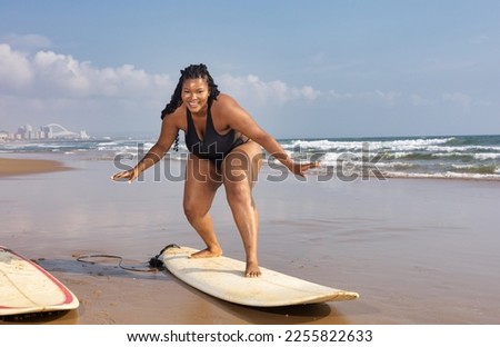 Plus size Black beautiful woman going surfing on the beach. Copy space. The concept of summer vacation body positivity holiday travel