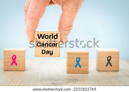 World Cancer Day on February 4. Colorful ribbons on the background of wooden cubes, Symbol of the fight against disease, National cancer survivors day, Health and oncology care concept