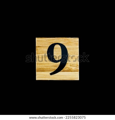 number 9 nine wooden isolated on black background

