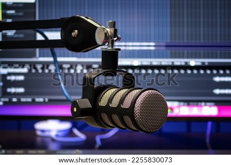 Close up studio condenser microphone for studio recording voice with colour lights background