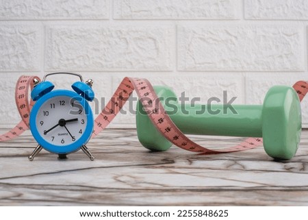 Exercise Plan Idea To Lose Weight. Clock On A Table And Dumbbell Time To Do Sports For Healthy Life.