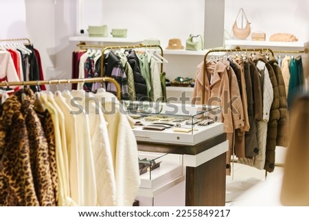 Background image of luxury boutique interior at shopping mall with clothes on hangers, copy space Royalty-Free Stock Photo #2255849217
