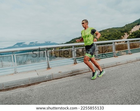 An athlete running a marathon and preparing for his competition. Photo of a marathon runner running in an urban environment